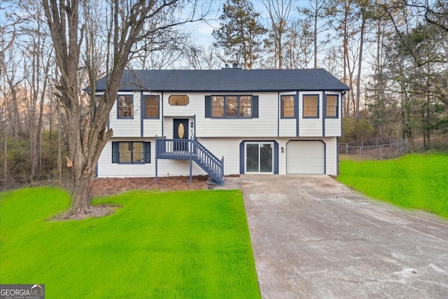 bi-level home with a front yard and a garage