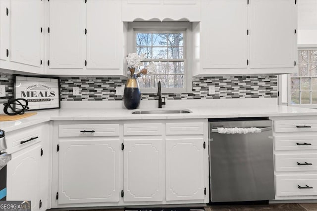 kitchen with white cabinetry, decorative backsplash, dishwasher, and sink