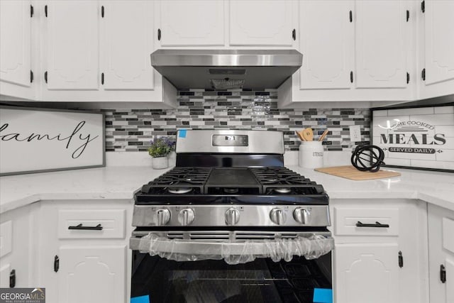 kitchen with wall chimney exhaust hood, white cabinets, and stainless steel range with gas cooktop