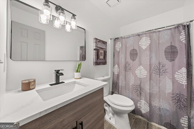 bathroom featuring toilet, vanity, a notable chandelier, hardwood / wood-style floors, and a shower with curtain