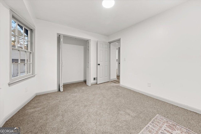 unfurnished bedroom with light colored carpet