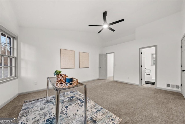 carpeted office space featuring ceiling fan and high vaulted ceiling