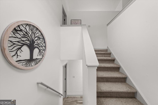 stairway featuring hardwood / wood-style flooring