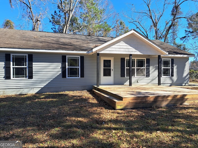 single story home featuring a deck and a front yard