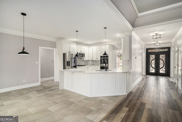 kitchen with french doors, pendant lighting, appliances with stainless steel finishes, and white cabinets