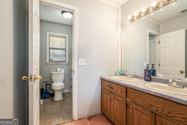 bathroom featuring vanity, toilet, and tile patterned flooring