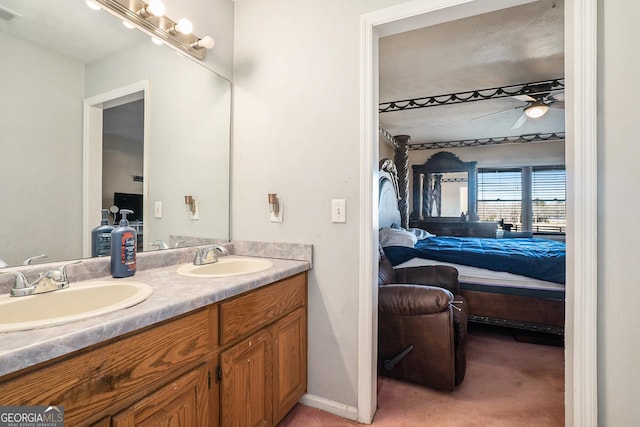 bathroom with ceiling fan and vanity