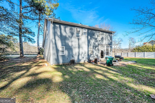 back of house with a patio area and a yard