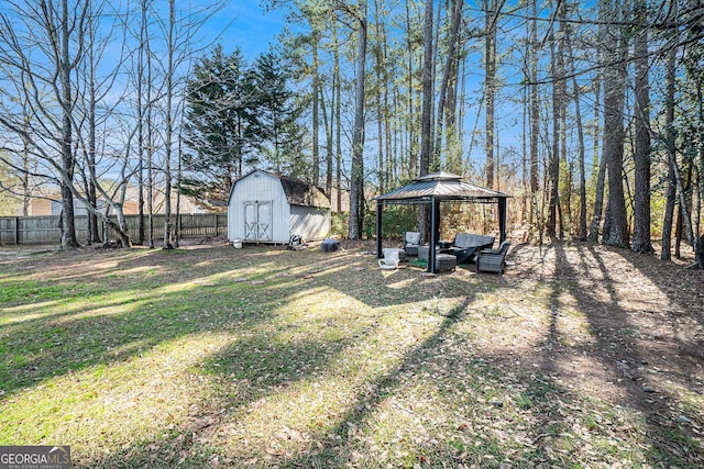 view of yard featuring a gazebo and a storage unit