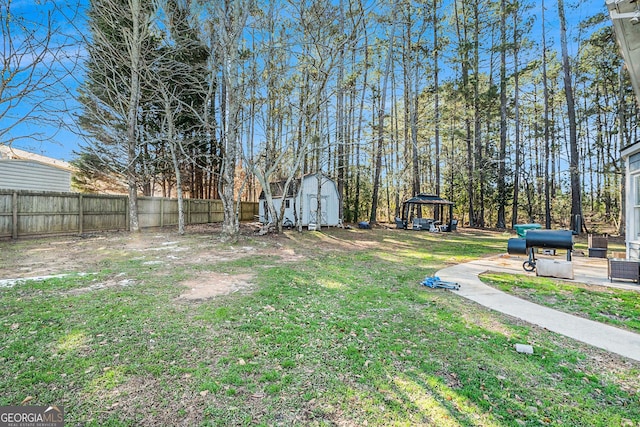 view of yard with a gazebo and a shed