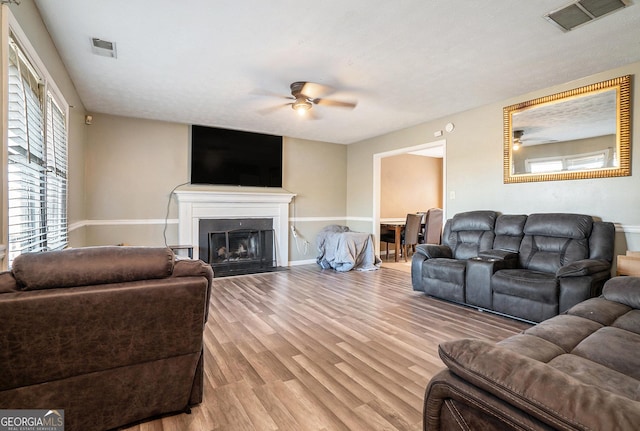 living room featuring ceiling fan and light wood-type flooring