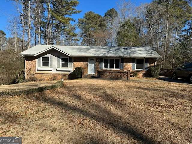 ranch-style home with a front lawn