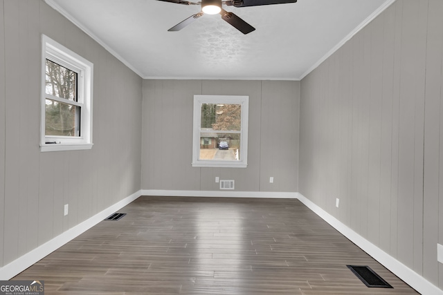 spare room with ceiling fan, dark hardwood / wood-style floors, and ornamental molding