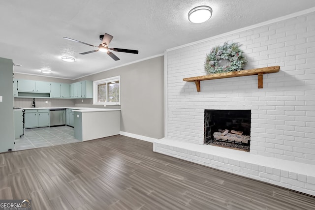 interior space with ceiling fan, a brick fireplace, crown molding, light wood-type flooring, and a textured ceiling