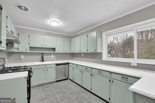 kitchen featuring appliances with stainless steel finishes, green cabinetry, a textured ceiling, crown molding, and sink