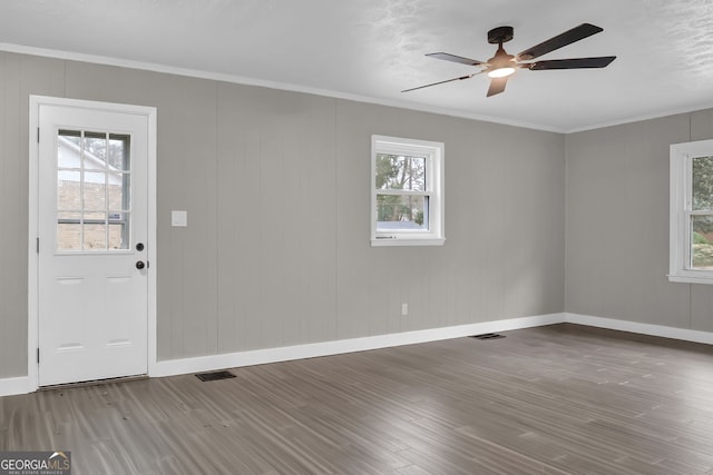 entryway with ceiling fan, plenty of natural light, crown molding, and hardwood / wood-style floors