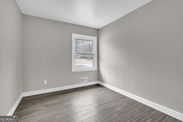 empty room featuring dark hardwood / wood-style flooring