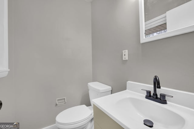 bathroom with toilet and vanity