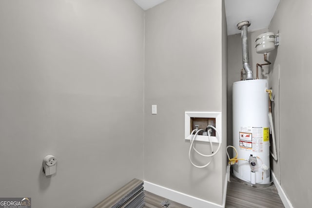 laundry room with water heater and hookup for a washing machine