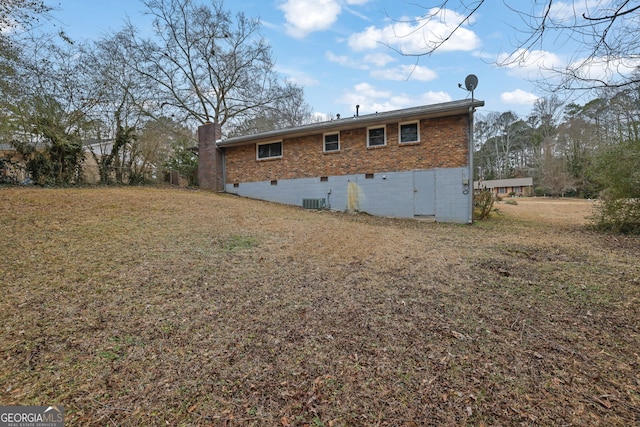 back of house featuring cooling unit and a yard