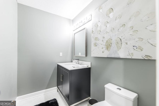 bathroom with toilet and vanity