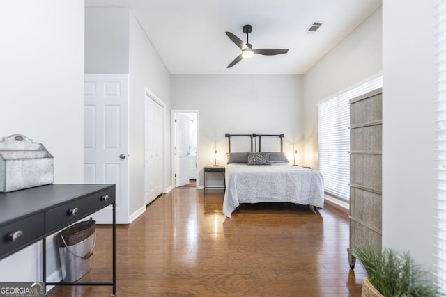 bedroom with ceiling fan and dark hardwood / wood-style floors