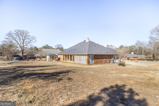 rear view of house with a yard