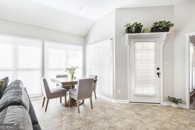 dining area featuring a wealth of natural light and lofted ceiling