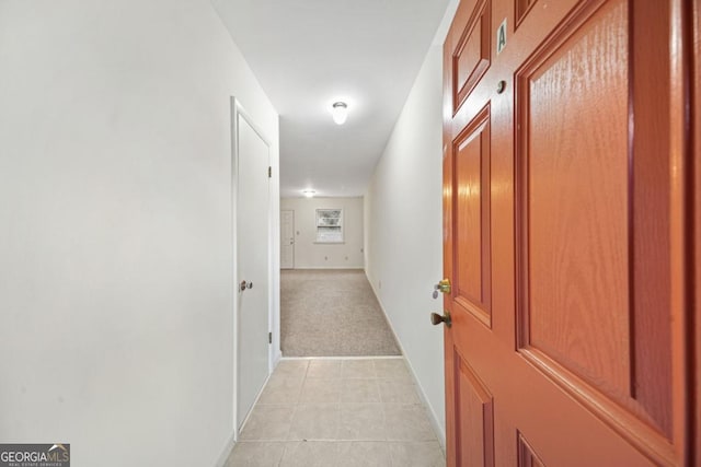 hallway featuring light colored carpet