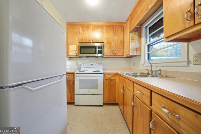 kitchen with sink and white appliances