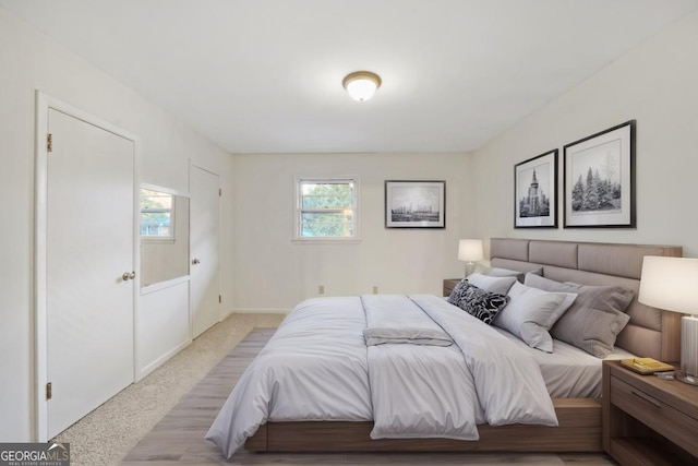 bedroom featuring light carpet