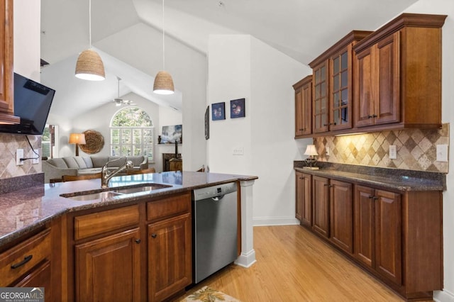 kitchen featuring dishwasher, decorative light fixtures, decorative backsplash, sink, and vaulted ceiling