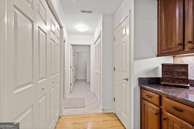 corridor featuring light tile patterned flooring