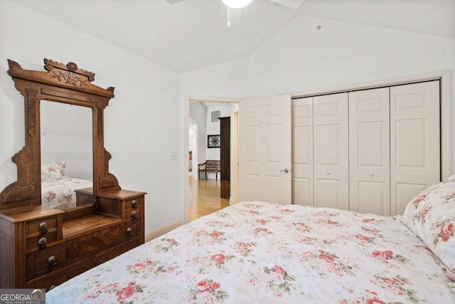 bedroom with ceiling fan, a closet, and lofted ceiling