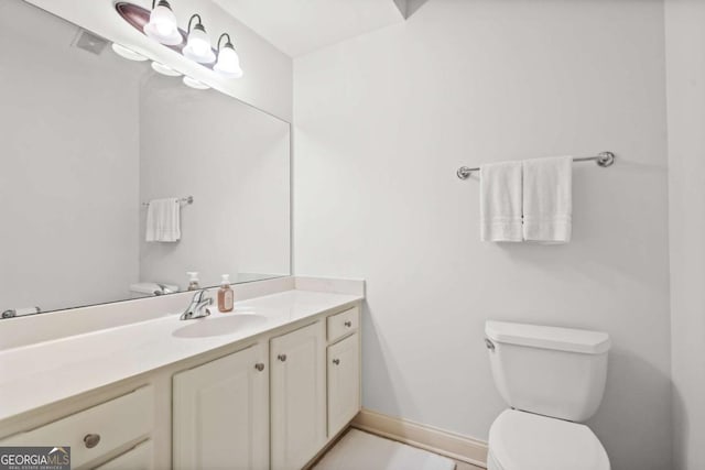 bathroom with toilet and vanity