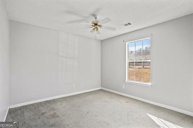 carpeted empty room featuring a textured ceiling and ceiling fan