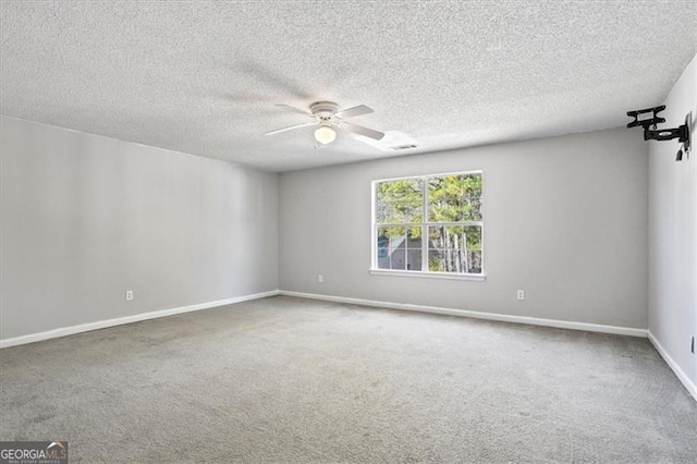 carpeted spare room with ceiling fan and a textured ceiling