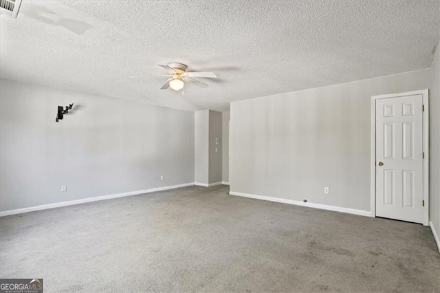 carpeted spare room with a textured ceiling and ceiling fan