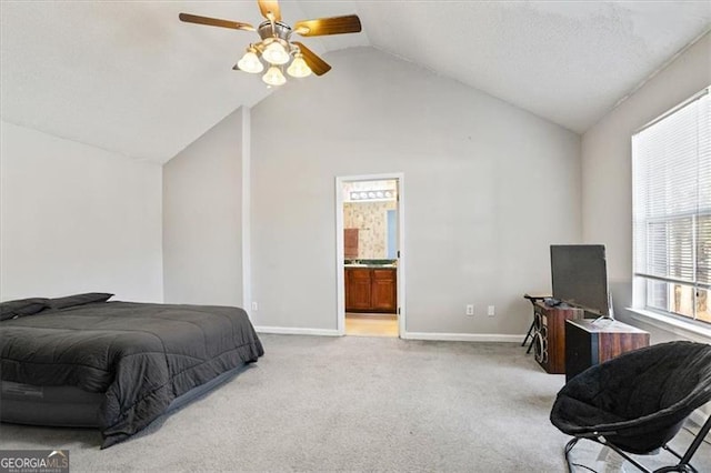 carpeted bedroom with ceiling fan, vaulted ceiling, and connected bathroom