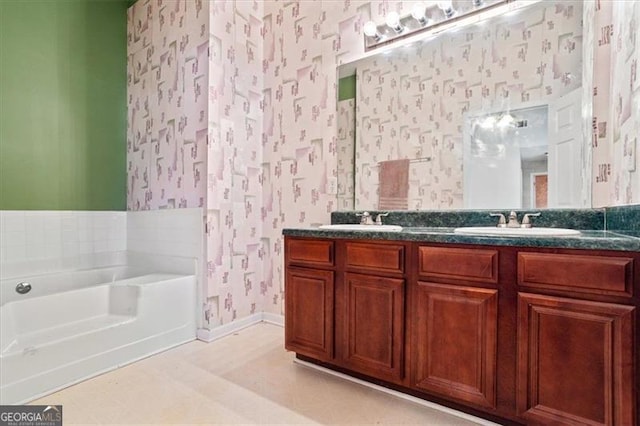 bathroom with a tub to relax in and vanity