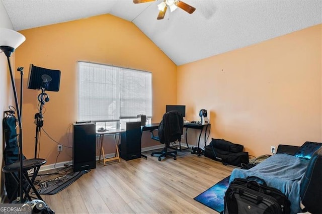 office featuring ceiling fan, lofted ceiling, and light hardwood / wood-style flooring