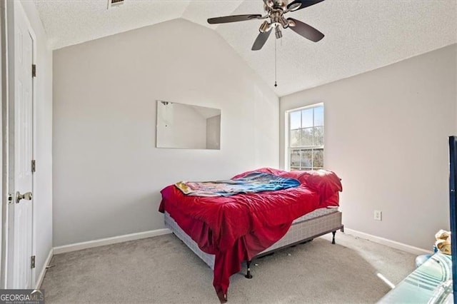 bedroom featuring ceiling fan, light carpet, a textured ceiling, and lofted ceiling