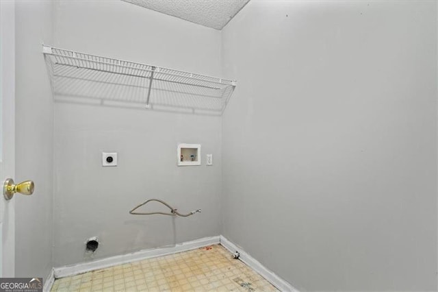 clothes washing area featuring a textured ceiling, hookup for a gas dryer, hookup for a washing machine, and electric dryer hookup