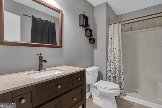 bathroom featuring vanity, tile patterned floors, toilet, and walk in shower