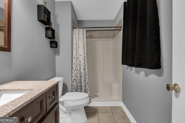 bathroom featuring tile patterned flooring, vanity, a shower with curtain, and toilet