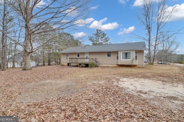 back of property featuring a wooden deck