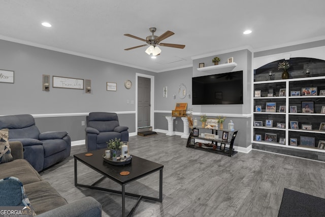 living room with crown molding, wood-type flooring, and ceiling fan