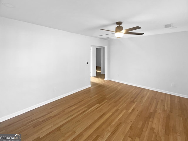 spare room with ceiling fan and wood-type flooring