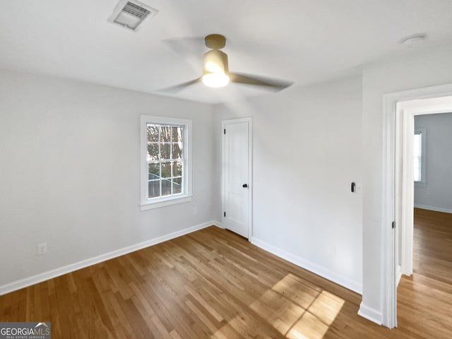 spare room featuring ceiling fan and hardwood / wood-style flooring