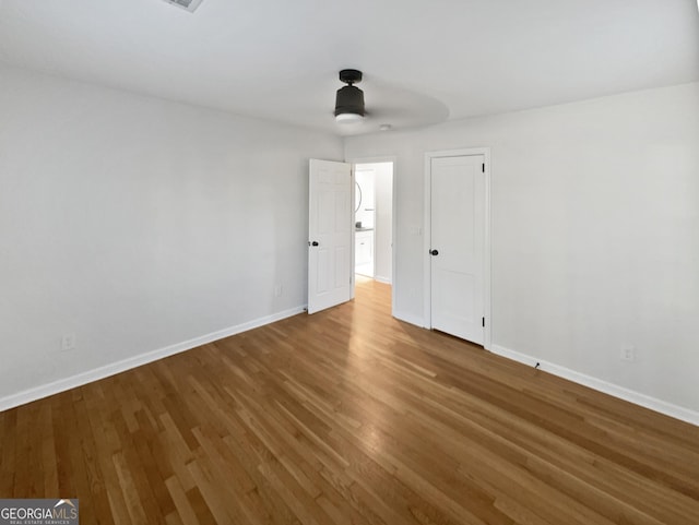 unfurnished bedroom featuring ceiling fan and hardwood / wood-style flooring